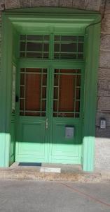 eine grüne Tür mit Fenstern auf einem Gebäude in der Unterkunft Apartmány Elisabeth in Železná Ruda