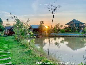 a view of a river with houses in the background at Rang Robin Farmstay for 4 with pool in Ban Wang Muang