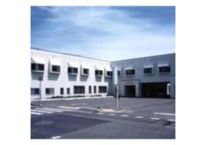 an empty parking lot in front of a white building at Mashu Onsen Hotel Mashu - Vacation STAY 69295v in Teshikaga
