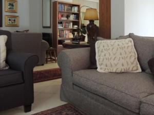 a living room with a couch and a chair at Gentle Breeze Retreat in Parys