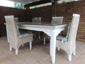 a white table and chairs on a patio at Gentle Breeze Retreat in Parys