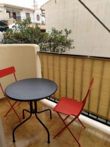 two chairs and a table on a balcony at Monísimo Pensión Rincón de la Victoria in Rincón de la Victoria