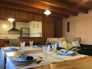 a table with plates and glasses on top of it at El Mirador de los Trobos in Villar de Otero