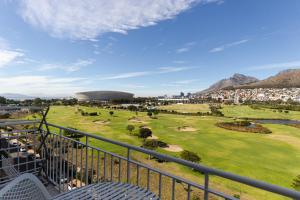 a view from the balcony of a golf course at Mouille Point Studio in Cape Town