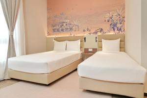 Postel nebo postele na pokoji v ubytování Cititel Express Ipoh + 37 fotografií