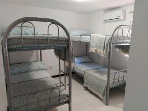 a room with two bunk beds and a staircase at Monísimo Pensión Rincón de la Victoria in Rincón de la Victoria