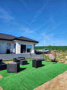 a yard with green grass and a house at NEW Luxury villa near Belgrade for 20 guests sleeps 8 in Vlaška