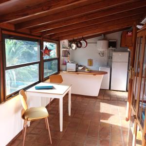 a kitchen with a white table and a white refrigerator at Casa Luis in Hermigua