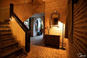 a hallway with a staircase and a mirror on the wall at Riad Zoraida in Marrakech