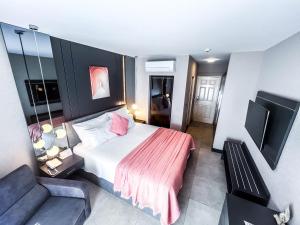 a hotel room with a bed and a couch at Belcekiz Beach Club - All Inclusive in Oludeniz