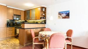 cocina con mesa, sillas y mesa en Apartment Riederhof, Riederalp, en Riederalp