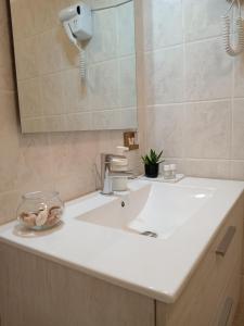 a bathroom with a white sink and a mirror at Sunrise in Monterotondo