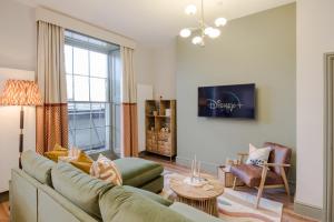 a living room with a couch and a table at Redland Place - Your Apartment in Bristol +52 photos
