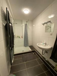 W łazience znajduje się wanna, umywalka i prysznic. w obiekcie Schönes Zimmer im Zentrum - 3 w mieście Paderborn