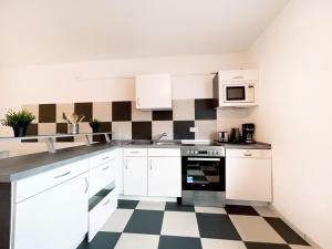Kuchyň nebo kuchyňský kout v ubytování Cozy Apartment + 9 fotografií