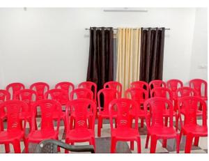 a group of red chairs in a room at Hotel Chaar Vedas, Uttarkashi in Uttarkāshi
