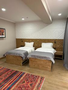 Krevet ili kreveti u jedinici u okviru objekta Dami Almaty Hotel