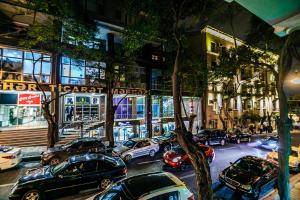 a group of cars parked on a city street at Monolit Apartment in Baku