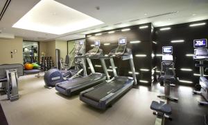a gym with treadles and ellipticals in a room at The Clermont London, Victoria in London