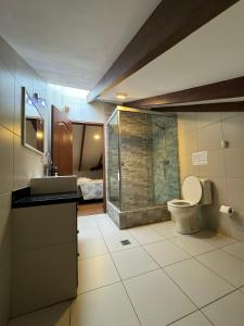 a bathroom with a toilet and a glass shower at Abis Terraza in Sucre