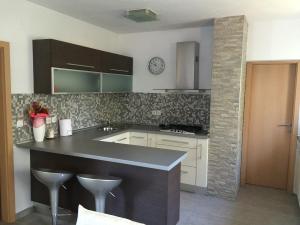 a kitchen with a large island in a kitchen at Apartment Casa Eni in Dražice +18 photos