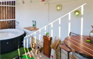 a bathroom with a tub and a table and a wooden table at Beautiful stacaravan In Raphle-les-arles With Kitchen in Raphèle