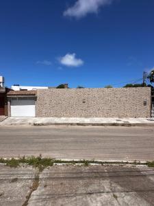 an empty street in front of a brick building at aconchegoreceptivo in Marechal Deodoro