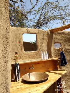 a bathroom with a sink and a mirror at Maji Moto Eco Camp in Maji Moto