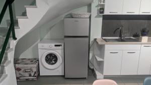 a kitchen with a washing machine and a sink at Grace : Garden and Terrace House in Kavala