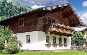 a large wooden house with a balcony at Große Ferienwohnung Grossarl in Grossarl