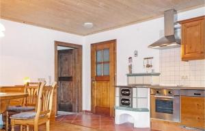 a kitchen with a table and a dining room at 4 Bedroom Amazing Apartment In Grossarl in Grossarl