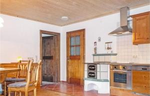 a kitchen with a table and a dining room at Awesome Apartment In Grossarl With 4 Bedrooms And Wifi in Grossarl