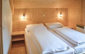 MurauにあるStunning Home In Murau With 4 Bedrooms And Saunaの木製の壁のベッドルーム1室(ベッド2台付)
