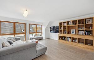a living room with a couch and book shelves at Amazing Apartment In Kehl-bodersweier With Wifi 