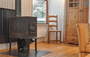 an old wood stove in a room with a chair at Stunning Home In Silkeborg With Wifi in Silkeborg