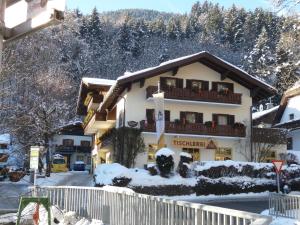 a large building with a balcony in the snow at Gästehaus Haffner in Zell am See