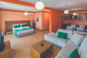 a living room with a couch and a bed at Apartments Deus in Dobra Voda