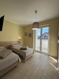 En eller flere senge i et værelse på Appartamento Corallo + 11 billeder