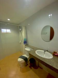 a bathroom with a toilet and a sink and a mirror at Chatchada House in Ao Nang Beach
