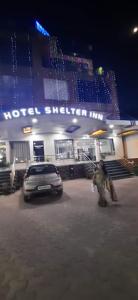 a car parked in front of a building at night at Hotel Shelter Inn,Chhatarpur in Chhatarpur