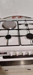 a white stove top with four burners on it at Pet friendly House in Tríkala