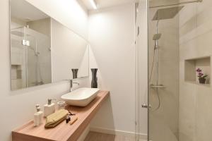 a bathroom with a sink and a shower at Blue Bay 153 by VillaGranCanaria in Meloneras