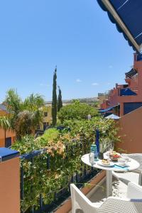 a table and chairs on a balcony with a view at Blue Bay 153 by VillaGranCanaria in Meloneras