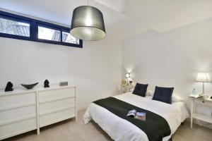 a white bedroom with a large bed and a window at Blue Bay 153 by VillaGranCanaria in Meloneras +45 photos