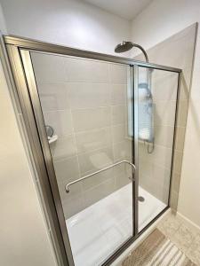 a shower with a glass door in a bathroom at New 4 Bedroom Home with Ocean and Gorgeous Mountain Views in the gated community of Mauna Olu in Waianae