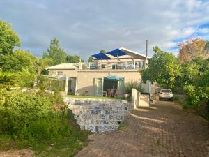 a house with a car parked in front of it at The View Swellendam B&B in Swellendam