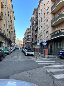 an empty street with cars parked on the sides of buildings at Bon Bon del Centro no Ztl a due passi da Piazza Alfieri in Asti