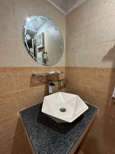 a bathroom with a sink and a mirror at Hotel Green Fort Gulberg in Lahore