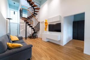 een woonkamer met een bank en een tv bij Loft Porta Maggiore in Rome +29 foto's