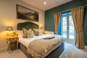 a bedroom with a large bed and a window at The Northey Arms in Box